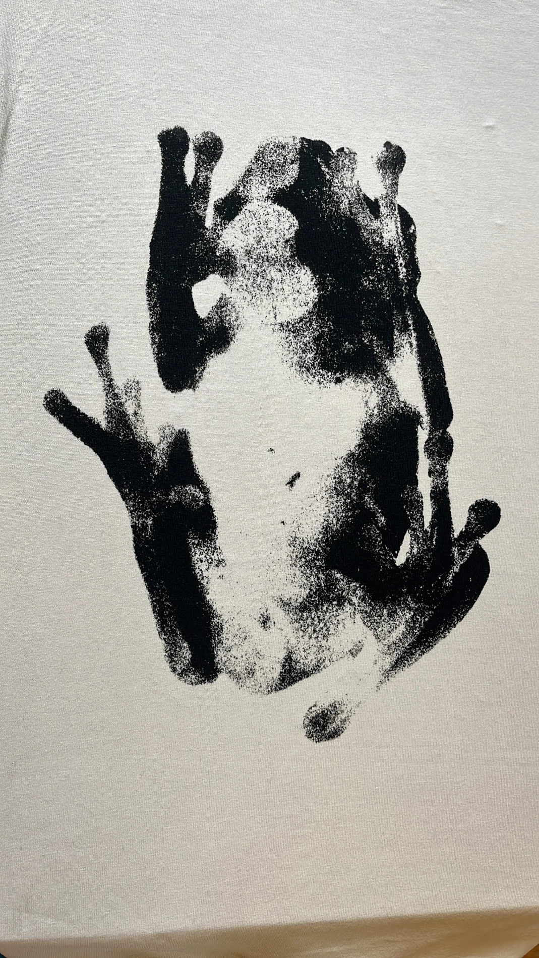 High contrast black photographic halftone print of a Portuguese frog on off-white fabric
